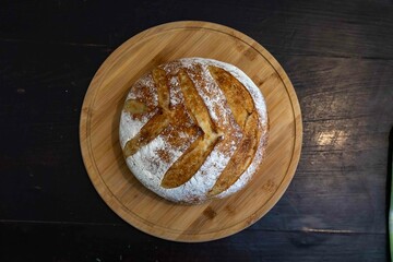 Freshly baked artisan sourdough bread on a wooden board.