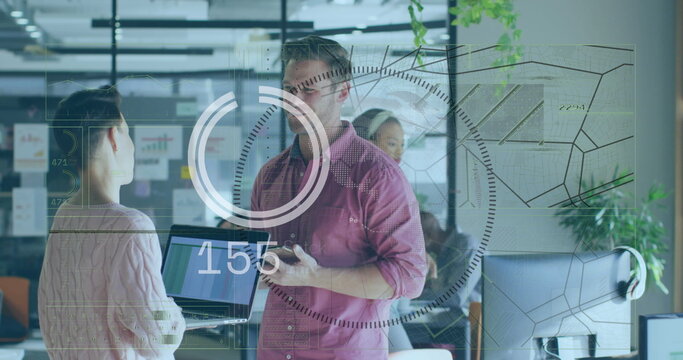 Man in red shirt holding smartphone and explaining data in office, with transparent display, laptop