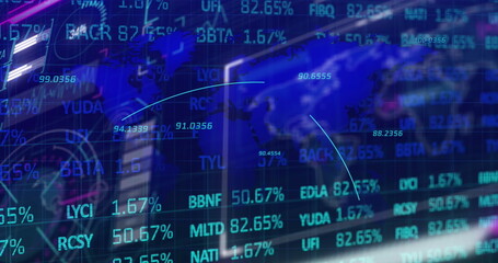 Showing financial market data overlay at desk monitors, with ticker symbols and world map graphic