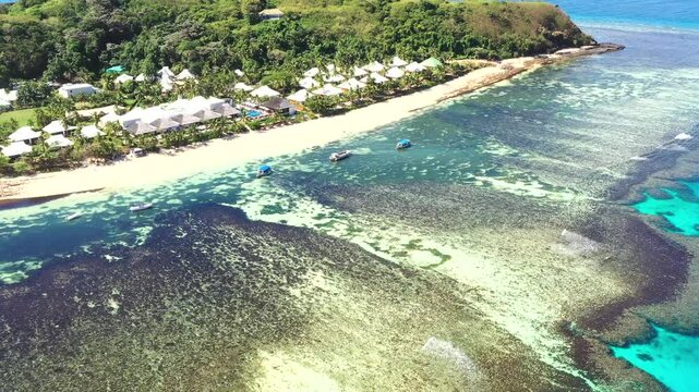 Shallow blue waters of Fiji Tokoriki island with coral reefs &ndash; aerial top down view 4k.
