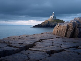 Lighthouse stands on rocky peninsula against cloudy sky. Coastal landmark, scenic seascape, remote location, travel destination