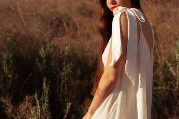 Model in white dress illuminated by soft sunset light