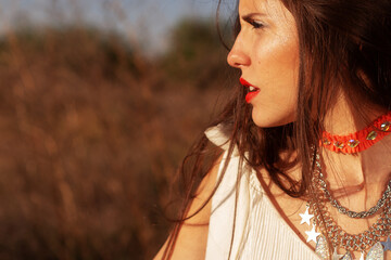 Chic summer fashion portrait in a scenic grassy field