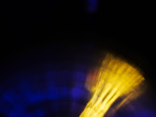 Abstract bokeh scene. Golden and blue glowing light leaks on black color background for design. Light effect.