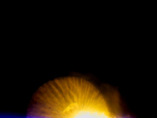 Abstract bokeh scene. Golden and blue glowing light leaks on black color background for design....