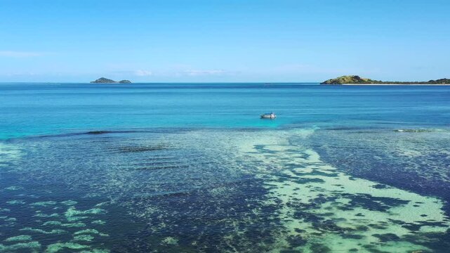 Remote islands in Pacific ocean at Fiji &ndash; aerial flying over coral reefs seascape as 4k.
