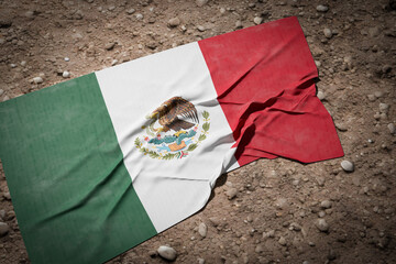Tattered and DIrty Mexican Flag Laying in the Dirt.