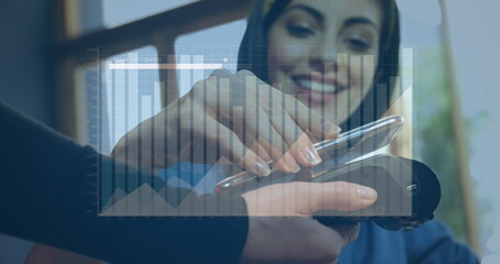 Assisting customer tapping smartphone, clerk holding card reader at shop counter with chart overlay