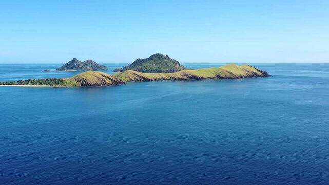 Group of rocky Pacific island in Fiji surrounded by coral reefs &ndash; aerial seascape 4k.
