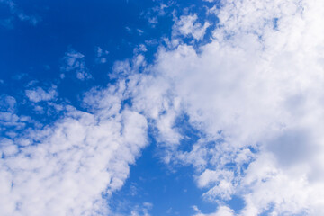 Obraz premium Clear blue sky, soft white clouds, sunny day, peaceful background, calm soothing environment