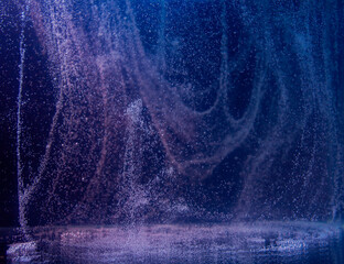 Water droplets create mesmerizing patterns in a dark environment