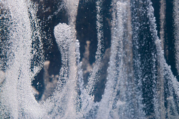 Water droplets create mesmerizing patterns in the air during a spray demonstration