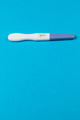 Pregnancy test indicating results on bright blue background