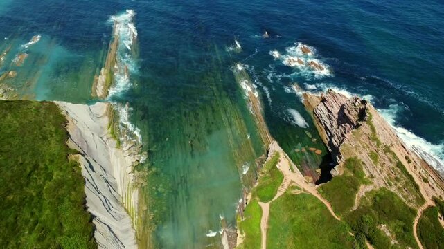 Breathtaking aerial perspective of zumaia's unique flysch coastline, showcasing geological formations and the beauty of basque country