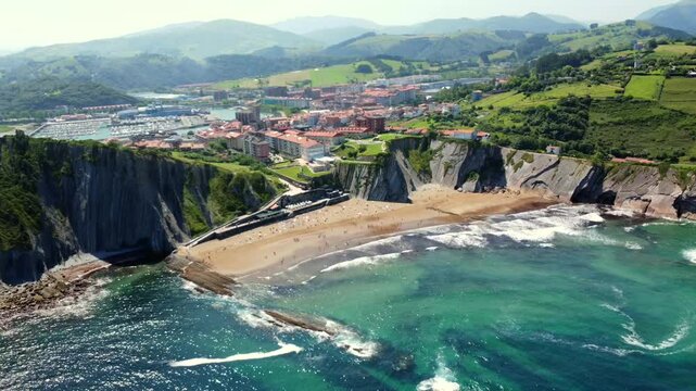 Zumaia cityscape and itzurun beach, nestled between imposing flysch cliffs, create a breathtaking coastal panorama