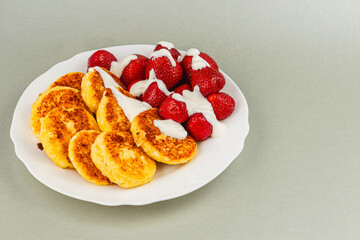 Delicious sweet pancakes with fresh strawberries and cream