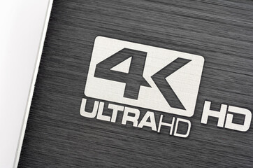 Generic 4k Ultra HD logo on a modern electronic device brushed metal surface high resolution video...