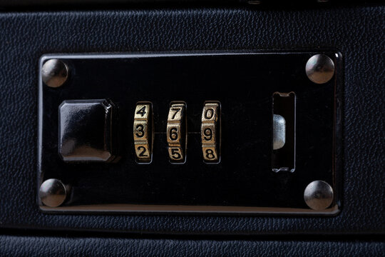Macro closeup of a combination lock on a premium business suitcase showing dial numbers 369 secure baggage concept black leather case travel safety expensive luggage protection abstract concept nobody
