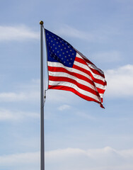 The American flag on the blue sky.