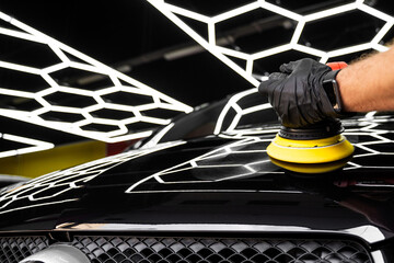 Car hood being polished with yellow pad. Paint polishing in active motion. Paint polishing to...