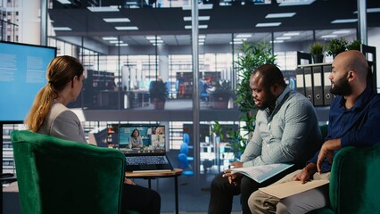 Professional team using video call technology to support company development and decision making,...