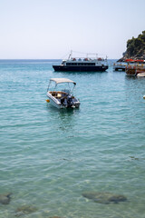 greek island bay with small boat and clear turquoise water