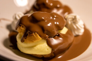 Delicious Profiteroles with Rich Chocolate Sauce and Cream
