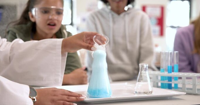 Multiracial students in science class observing exciting chemical reaction, at school