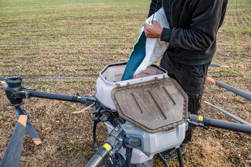 Farmer technicians prepare to remotely fly agricultural drones to fly to spray fertilizer in fields. Agricultural technology smart farm concept.