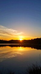 Obraz premium Sunset over calm lake. (1)