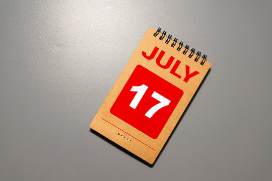 July 17 calendar date text on wooden blocks with blurred background park