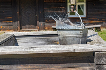 Water splashes from a bucket in a historic well