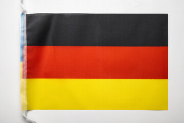 Closeup view of the German national flag isolated over a white background. Concept of government and nationality