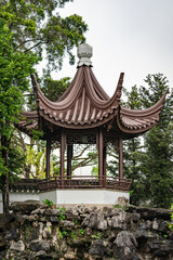Fototapeta premium Traditional Chinese pavilion nestled among lush greenery in a serene garden setting in the Chinese Garden of Singapore