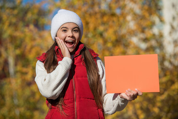 fall discount. teen girl presenting fall season discount. seasonal sale. autumn girl hold blank...