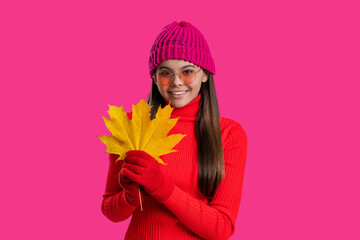 Autumn foliage. Autumn and leisure. Fall leaves and beautiful girl. Stylish girl hold maple leaves. Fall season. Hello autumn. Carefree teen girl in hat and gloves isolated on pink. Amber leaves