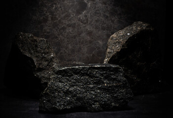 natural black stones with texture on dark background for presentation of products medicine...