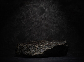 natural black stones with texture on dark background for presentation of products medicine...