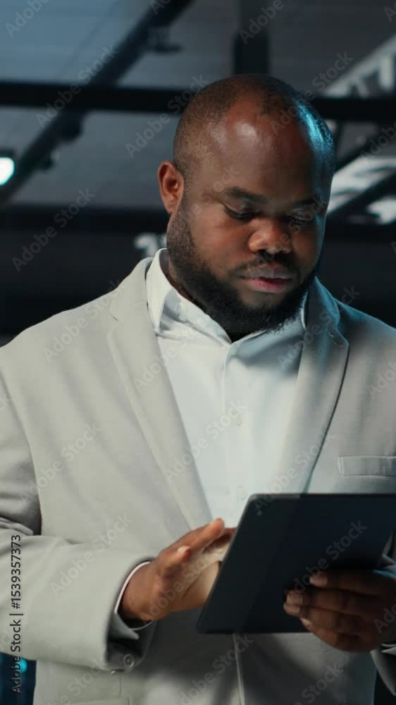 Poster vertical video system administrator walking in data center analyzing infrastructure performance outp