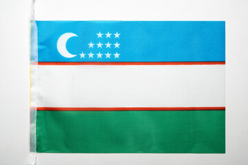 Closeup view of the Uzbekistan Republic national flag isolated over a white background. Concept of government and nationality