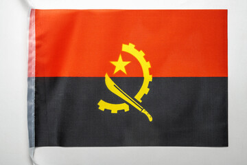 Naklejka premium Closeup view of the Angola Republic national flag isolated over a white background. Concept of government and nationality
