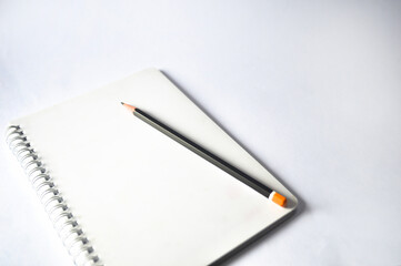 notebook and pencil isolated on white background