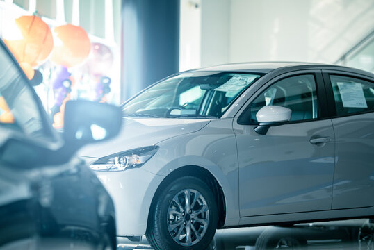 Fototapeta Car parked in luxury showroom. Car dealership office. Car showroom business. New car parked in modern showroom. Auto for sale and rent business. Automobile leasing and insurance. Electric automobile.