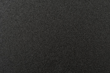 Shiny wrapper paper. black sandpaper texture background.