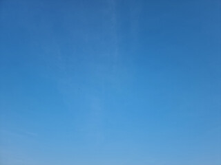 Clear Bright Blue Sky Background with Subtle Wisps