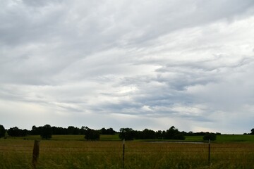 Fototapeta premium Clouds Over a Farm Field