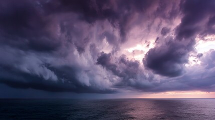 Fototapeta premium Dramatic ocean view with stormy clouds and twilight hues over the water.