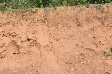 Pile of soil. The soil has been dug out and kept to make Clay brick. Red soil in Natural environment.
