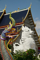 Statues of Naga and Singha, which are animals in Thai art, decorate the front of the ordination hall and chapel at Wat Den Sali Si Mueang Kaen temple. Located at Cheng Mai Province in Thailand.