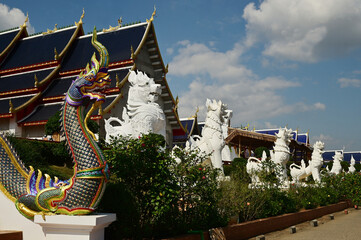 Statues of Naga and Singha, which are animals in Thai art, decorate the front of the ordination hall and chapel at Wat Den Sali Si Mueang Kaen temple. Located at Cheng Mai Province in Thailand.